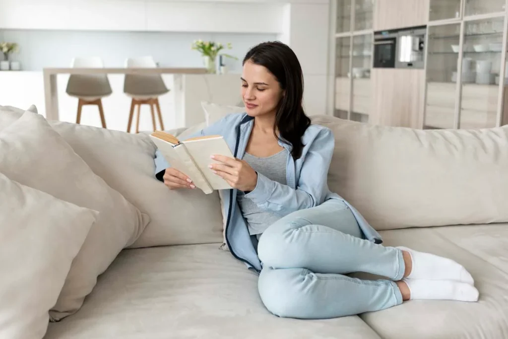 A-relaxed-homeowner-reading-a-book-in-their-professionally-cleaned-living-room.webp
