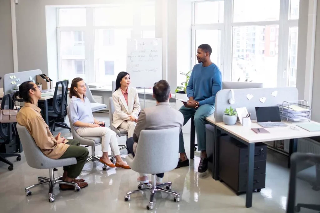 Happy employees working together in a clean and organized corporate conference room