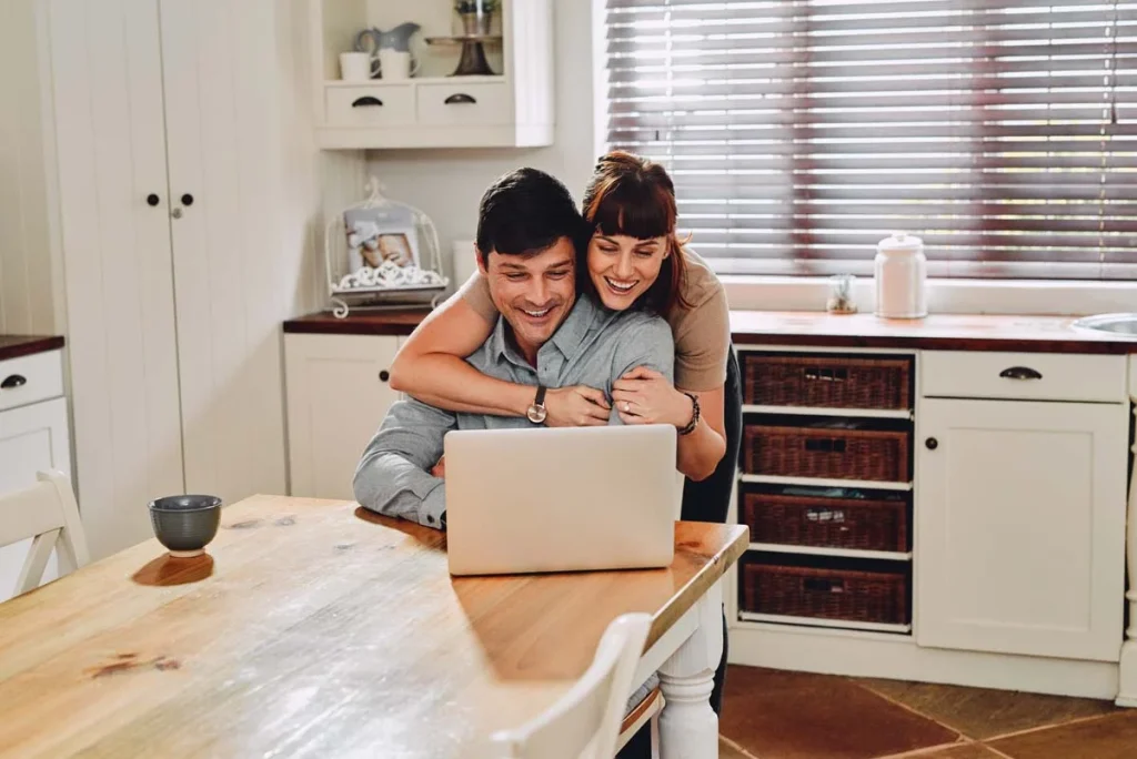 Homeowners-using-a-laptop-to-request-a-free-house-cleaning-quote-online.webp